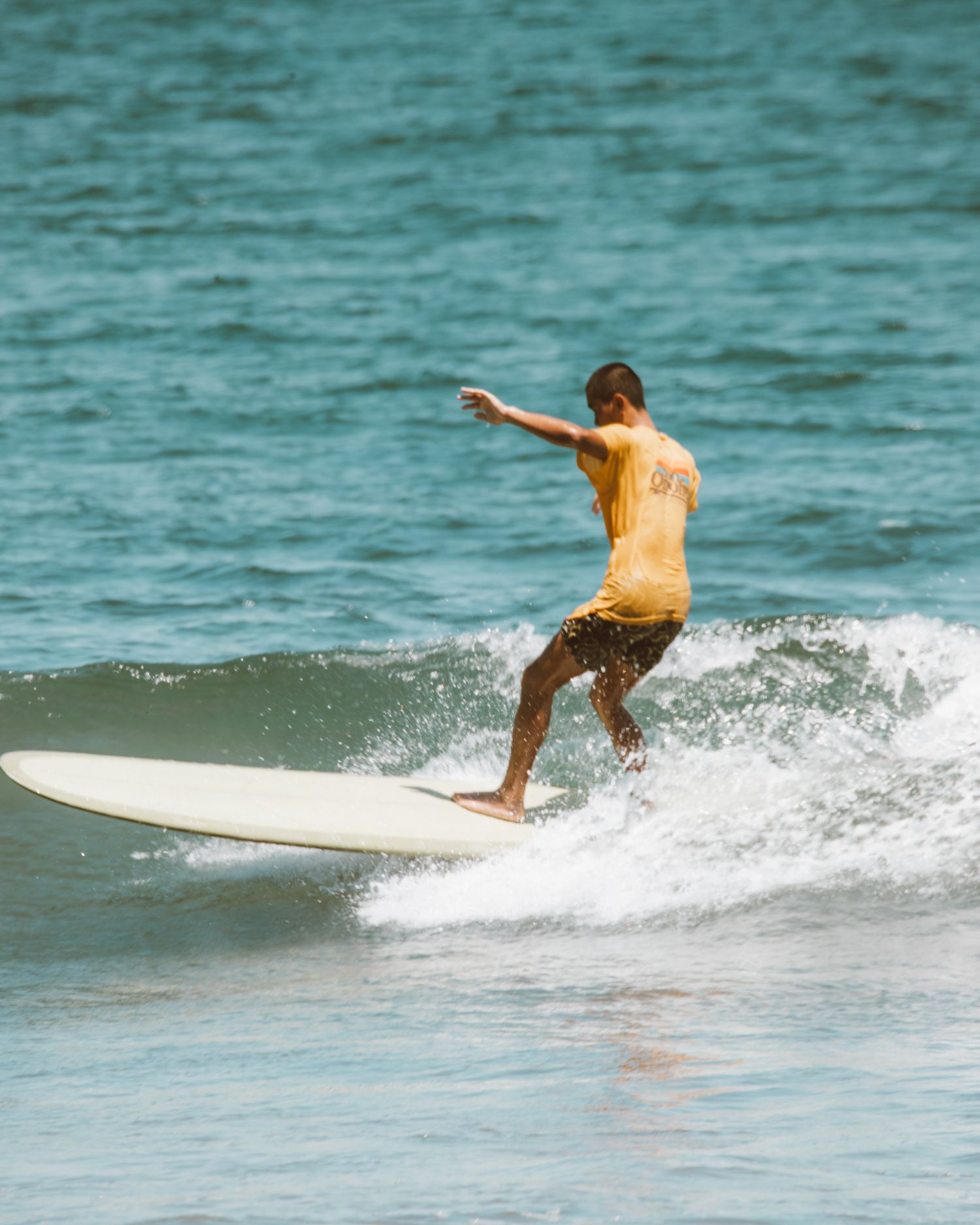 Surfer silhouette against a golden-hour sunset